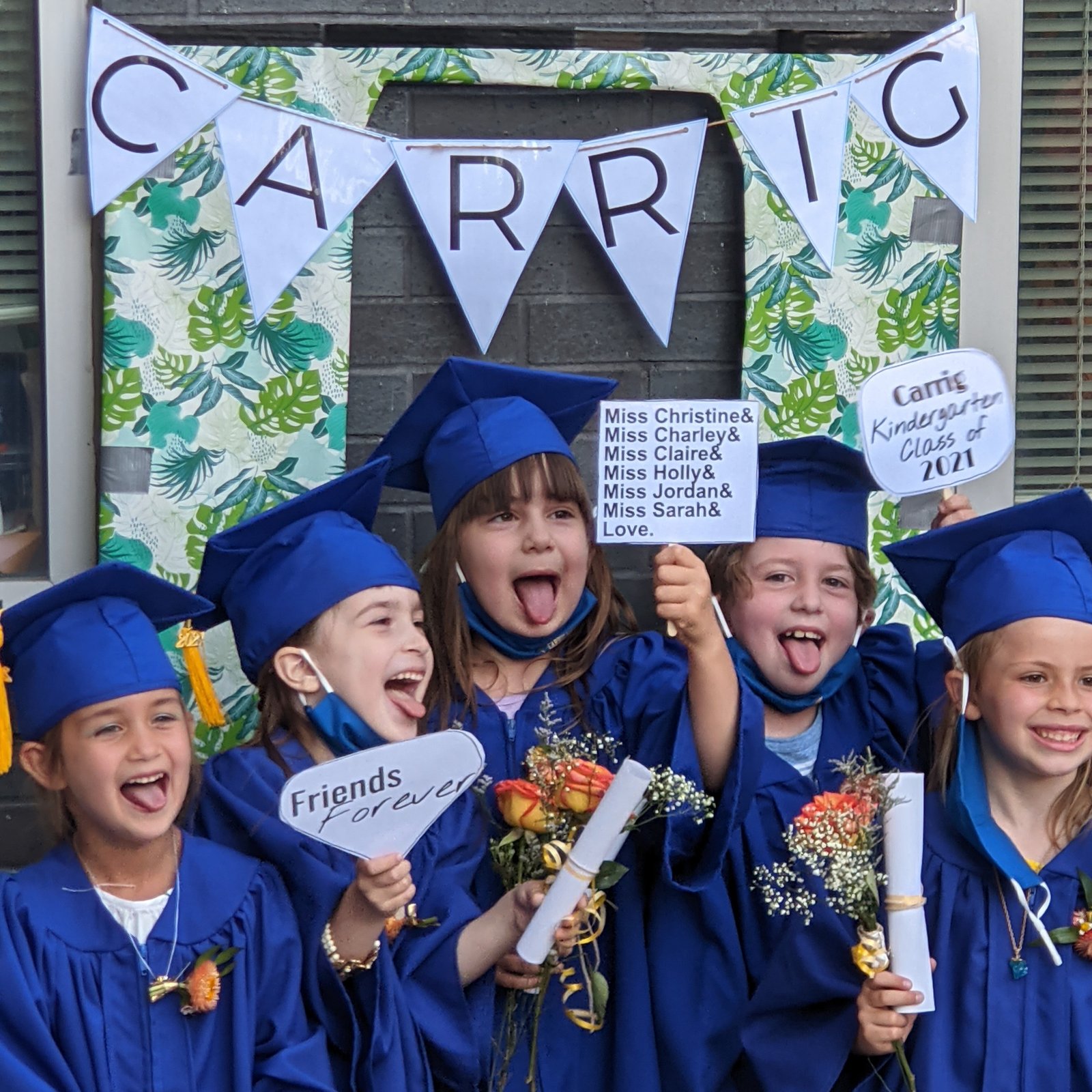 Carrig Montessori kindergarten graduates celebrating together in blue caps and gowns